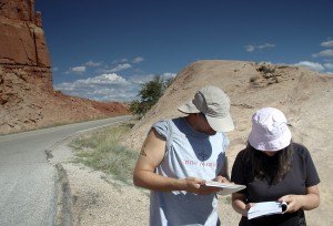 People reading guide books outdoors People reading guide books outdoors