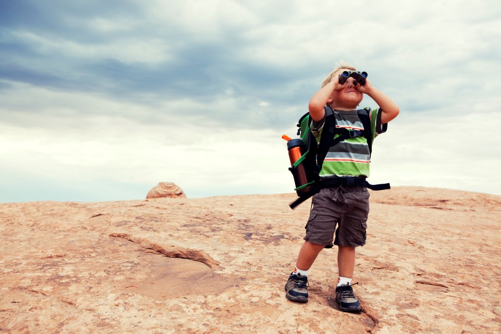 Kid looking through binoculars outside Kid looking through binoculars outside