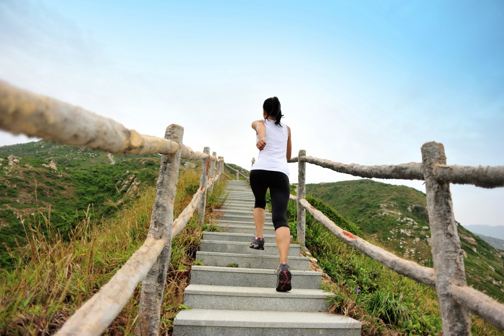 Woman running up the stairs Woman running up the stairs