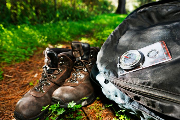 Hiking gear on a trail - books, pack, compass Hiking gear on a trail - books, pack, compass